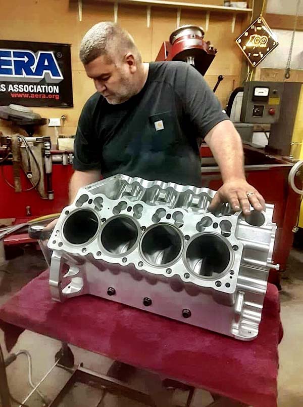 John working on a dragster motor